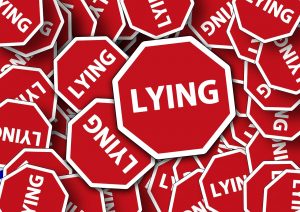 The word lying surrounded by a red stop sign.